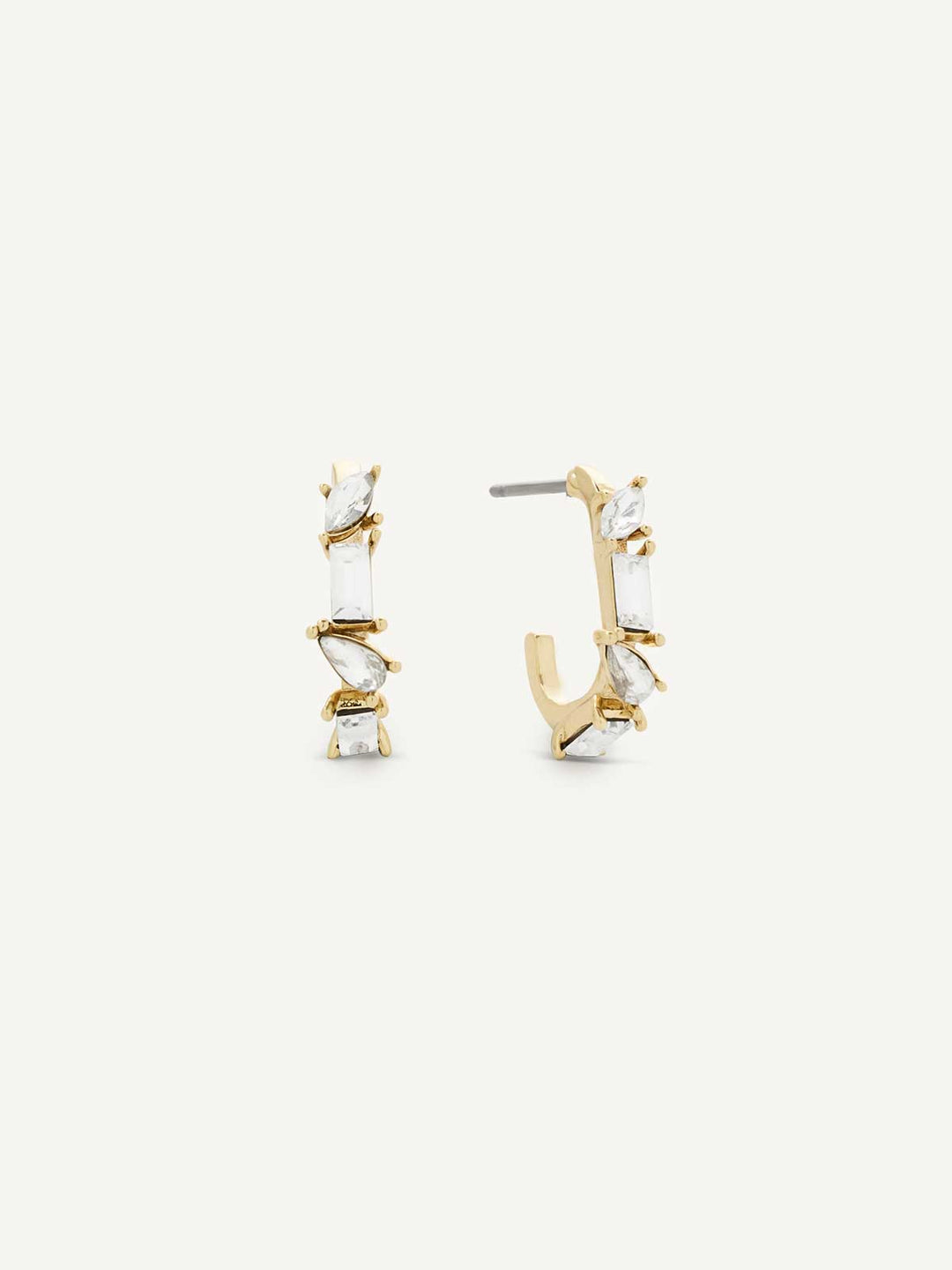 Gold and crystal hoop earrings on a white background