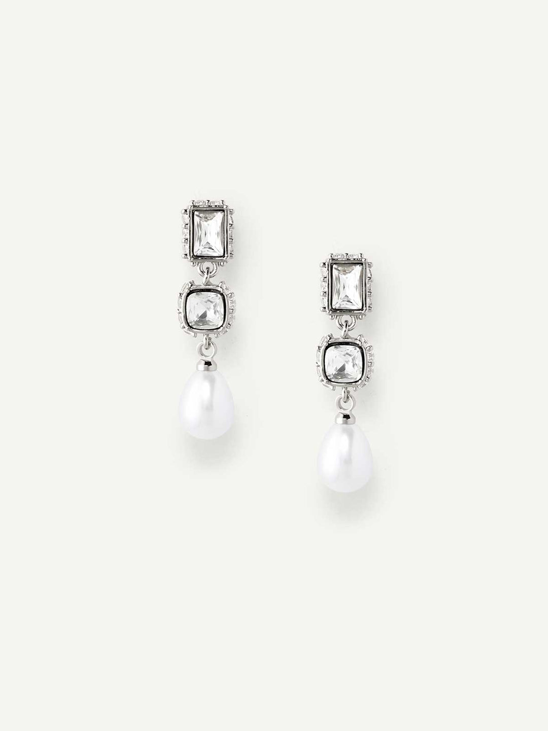 Pair of silver drop earrings with gemstones and pearls on a white background